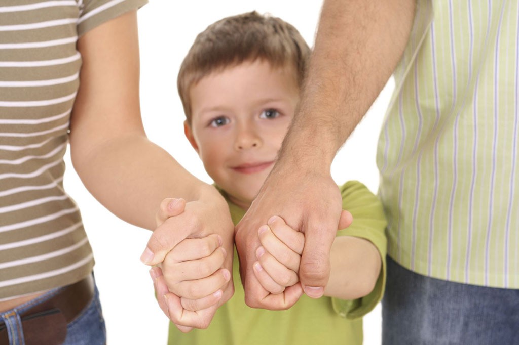 Child holding adult hands